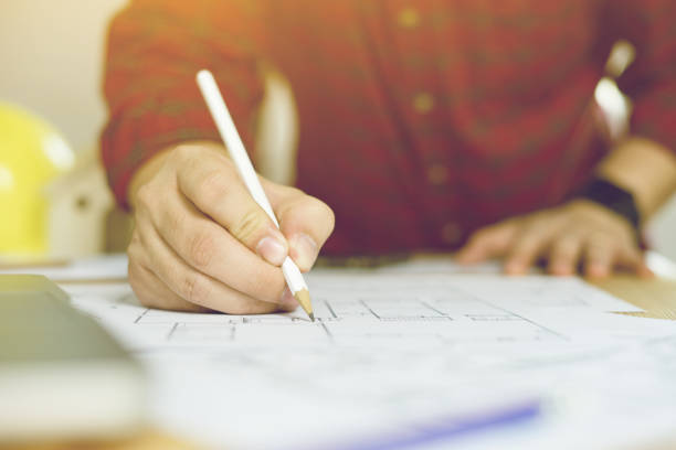 istock Close up of engineers hands working on table with pencil,engineer meeting for architectural project. working with partner and engineering tools on workplace vintage color 1125842056