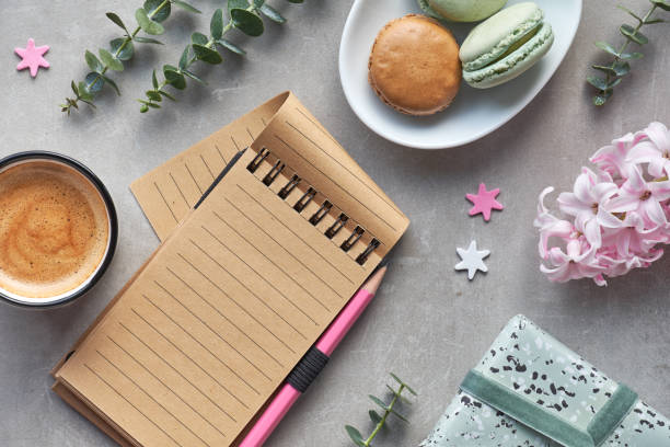 istock Springtime flat lay with pink hyacinth, eucalyptus, mobile phone, blank notebook, coffee and macarons 1125842191