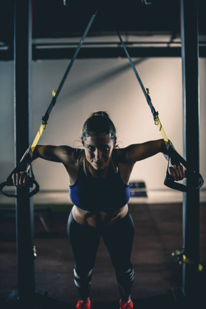 istock Confident woman doing TRX suspension training 1125842938