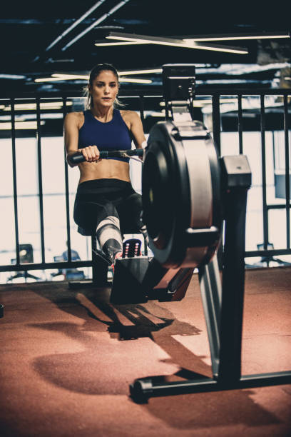 istock Fit woman doing rowing machine workout at the gym 1125843345