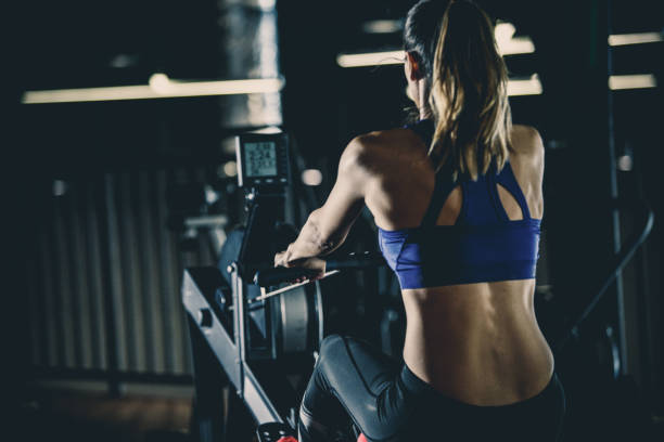 istock Fit woman doing rowing exercise in the gym 1125843464