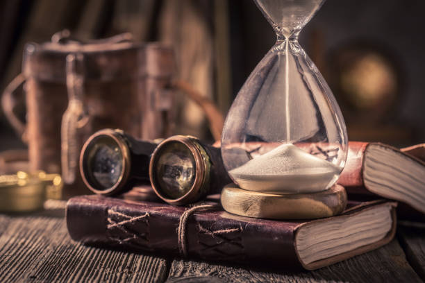 istock Old hourglass and journal as a concept of journey diary 1125844641