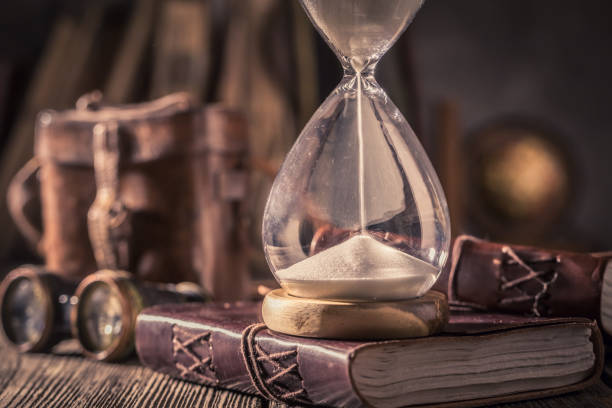 istock Old hourglass and journal with compass and binocular 1125844702