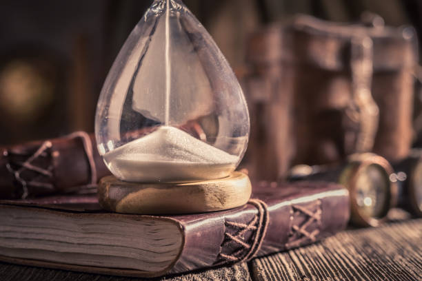 istock Vintage hourglass and journal with compass and binocular 1125844716