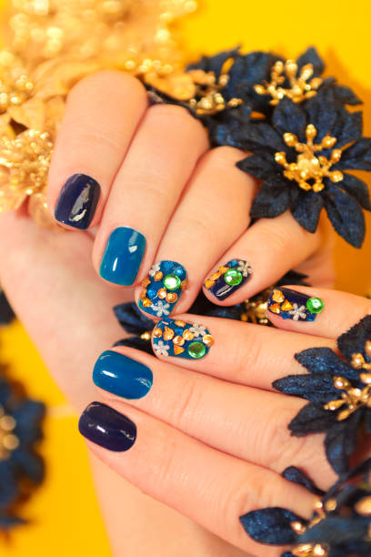 istock Bright blue manicure with the design of rhinestones. 1125848183
