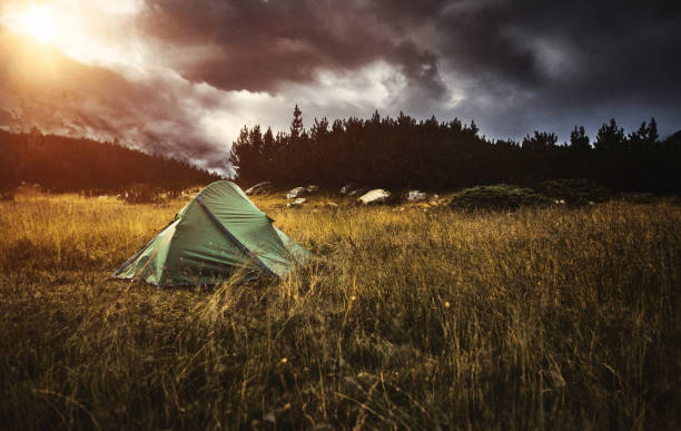 istock Camping in a Tent in the Mountains at Sunset 1125848959