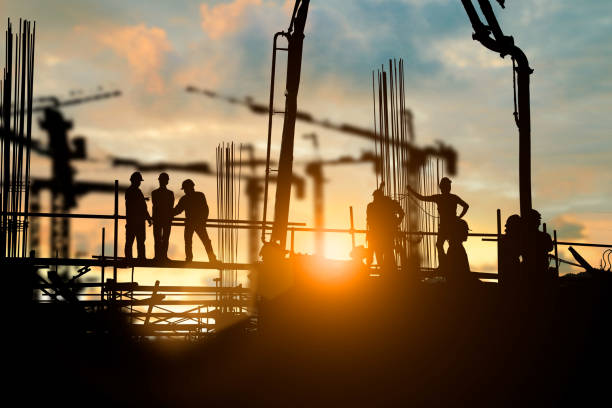 istock Silhouette of engineer and construction team working at site over blurred background for industry background with Light fair.Create from multiple reference images together 1125849378