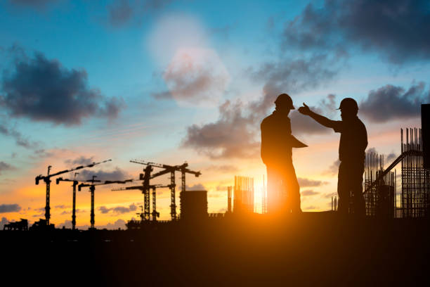 istock Silhouette of engineer and construction team working at site over blurred background for industry background with Light fair.Create from multiple reference images together 1125849379