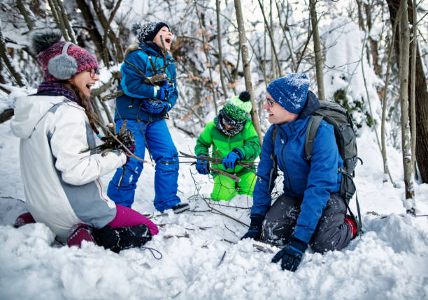 istock Family gathering firewood in winter forest 1125852917