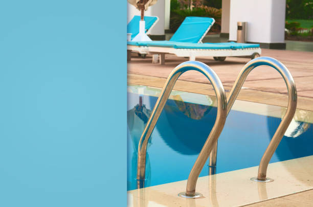 istock swimming pool with blue water and a metal staircase 1125854953