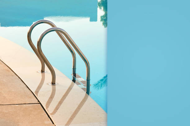 istock swimming pool with blue water and a metal staircase 1125854954