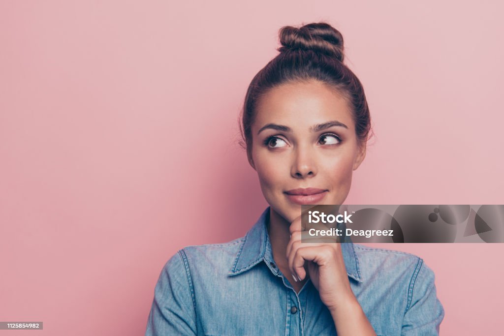 Close-up portrait of her she nice cute attractive winsome charmi Close-up portrait of her she nice cute attractive winsome charming fascinating minded lady wearing blue shirt touching chin isolated over pink pastel background Women Stock Photo