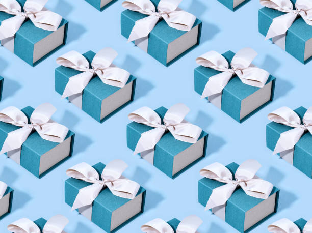 istock Pattern made of blue gift boxes on pastel background. 1125855057