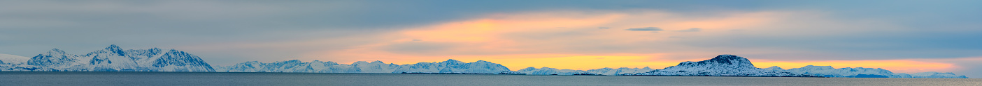 View in the Selfjord on the island Senja in Northern Norway during a beautiful winter day. View from Grunnfarnes village on the Norwegian Sea with various snow covered islands in the distance.
