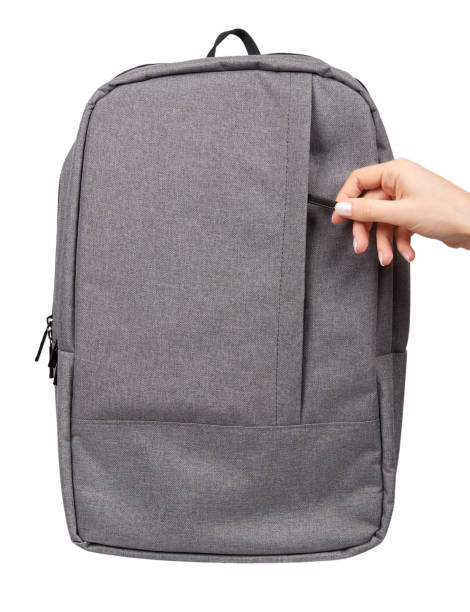istock Hand with gray textile school bag, city street backpack 1125856697