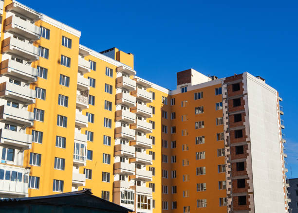 istock Thermal exterior insulation of new multi-storey building under clear blue sky 1125857946