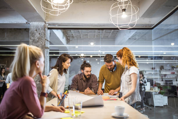 istock Group of young creative people working at casual office. 1125860364