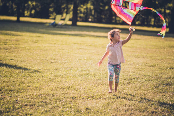 istock Girl running with kite in nature 1125863207