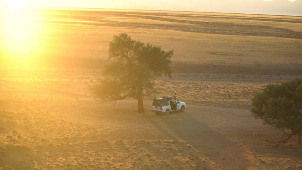 istock Large African plains. Savannah sunset with camping in SUV 1125867015