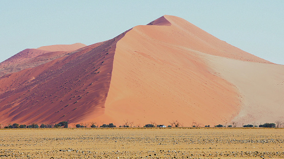 Sossusvlei is a salt and clay pan surrounded by high red dunes, located in the southern part of the Namib Desert, in the Namib-Naukluft National Park of Namibia.