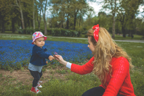 istock Young mother and child playing in the park 1125868308
