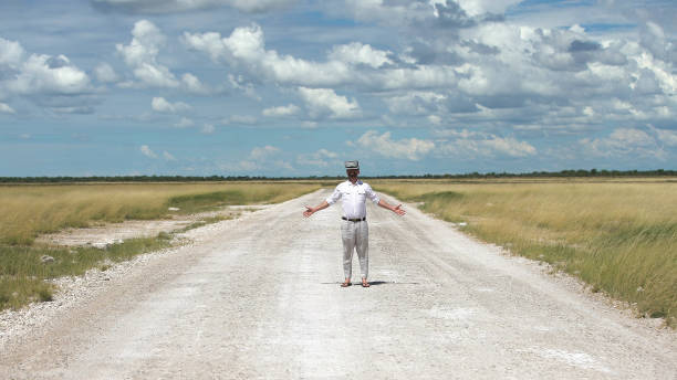 istock Man opening arms savannah road. Exploring virtual reality 1125868985