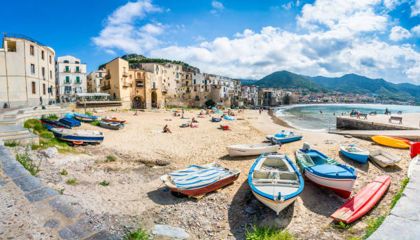 Cefalu, Sicily - September  24, 2018: Landscape with beach and medieval Cefalu town, Sicily island, Italy