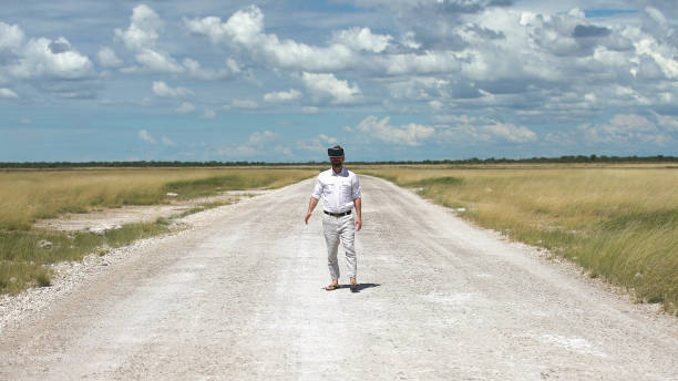 istock Man opening arms savannah road. Exploring virtual reality 1125869009
