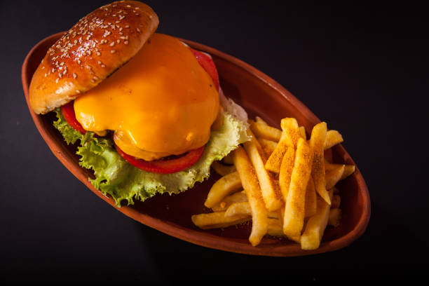 istock Burger and fries on casserole on dark  background 1125871071
