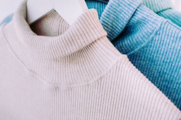 istock Warm pastel sweaters hang on a hanger. 1125871747