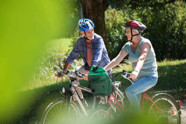 istock Senior couple on a bicycle tour in park 1125871805