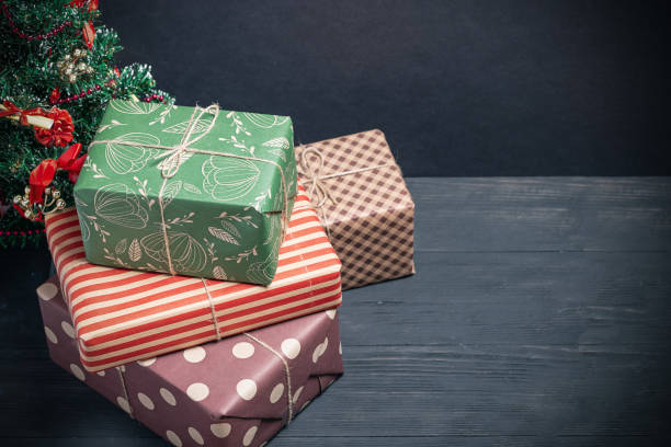 istock Varied and bright gifts under the Christmas tree on a black background 1125872233