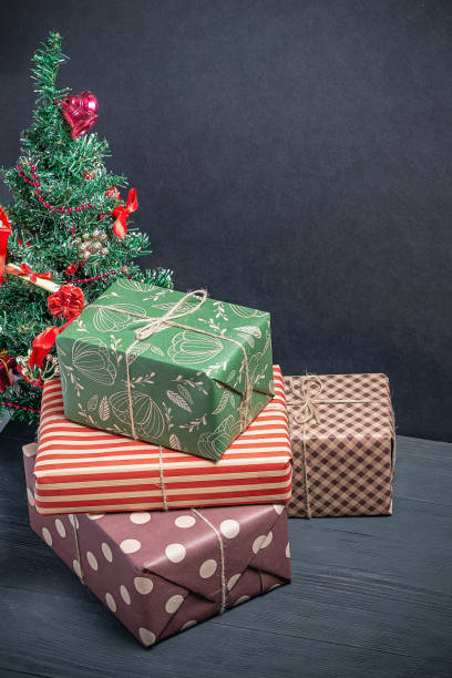 istock Varied and bright gifts under the Christmas tree on a black background 1125872239