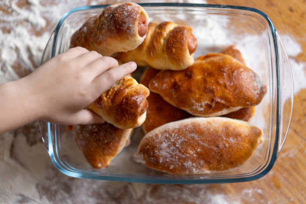 istock the child took the pie from the table. close-up 1125872277