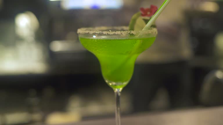 Fruit cocktail decorating fruits on bar counter on restaurant. Close up green and orange fruit cocktail drink in restaurant