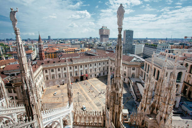The City of Milan from Duomo Milan, Italy - May 1, 2018: Tourists Gather in the Duomo Plaza, with the Milan Skyline in the Background. milan fashion week stock pictures, royalty-free photos & images