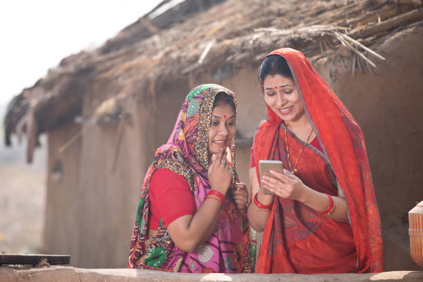 istock Rural women using mobile phone at village 1125873451