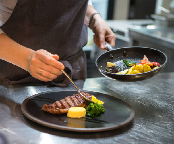 istock Chef puts the dish on a plate. Preparing to serve. 1125875040