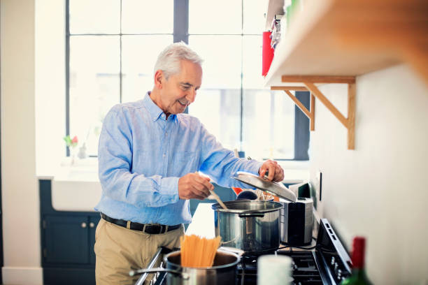 istock Retired man stirring meal in cooking utensil 1125875052