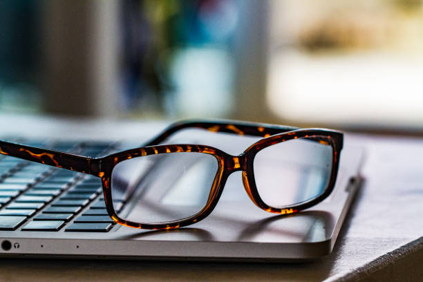 Take a break, Spectacles on Laptop stock photo