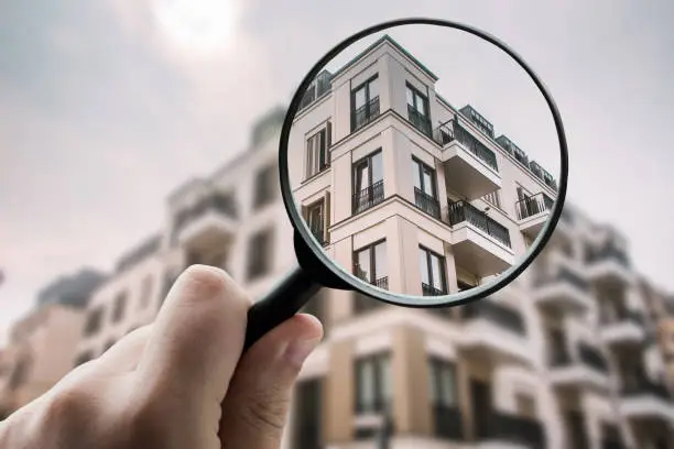 A magnifying glass over residential buildings
