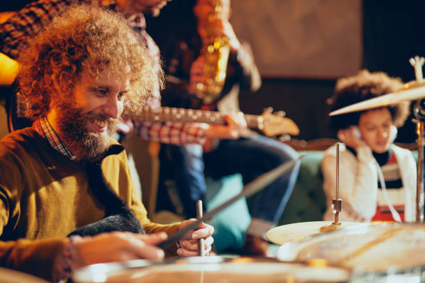istock Caucasian drummer playing his instrument while sitting in home studio. 1125877777