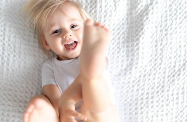 Little Happy Kid Laughing on White Background. Children's Concept. Motherhood