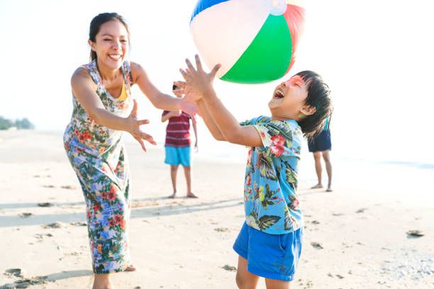 Asian family playing at the beach