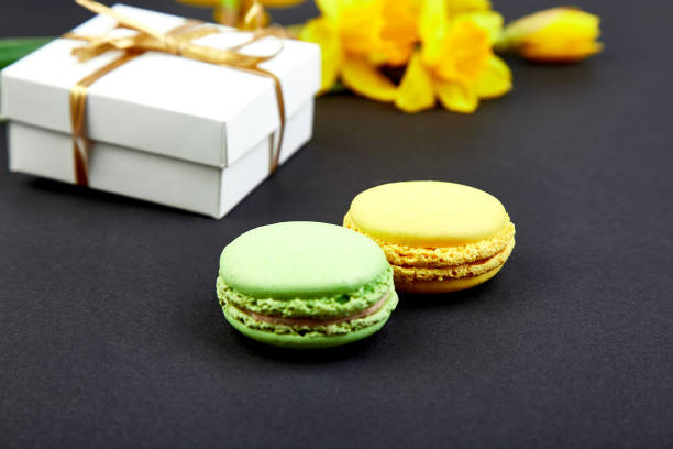 istock Bouquet flowers narcissus gift and sweets or cake macarons. 1125878276