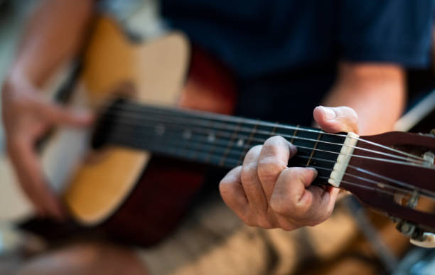 istock Senior man playing on his guitar 1125880062