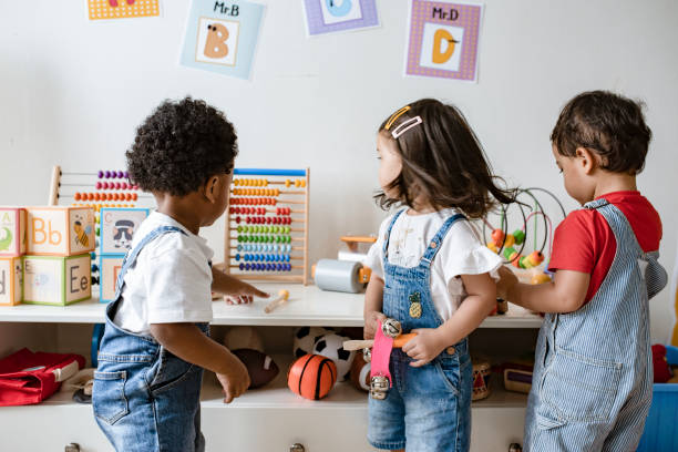 Young children playing with educational toys Young children playing with educational toys preschool student stock pictures, royalty-free photos & images