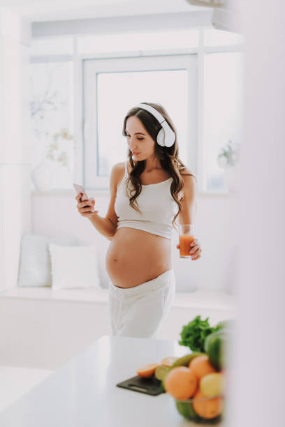 istock Future mom listening music and holding cellular 1125881969