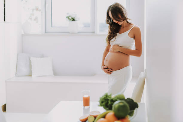 istock Excited glad woman holding hands on stomach 1125881996