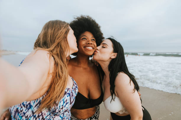 istock Beautiful curvy women taking a selfie at the beach 1125884039